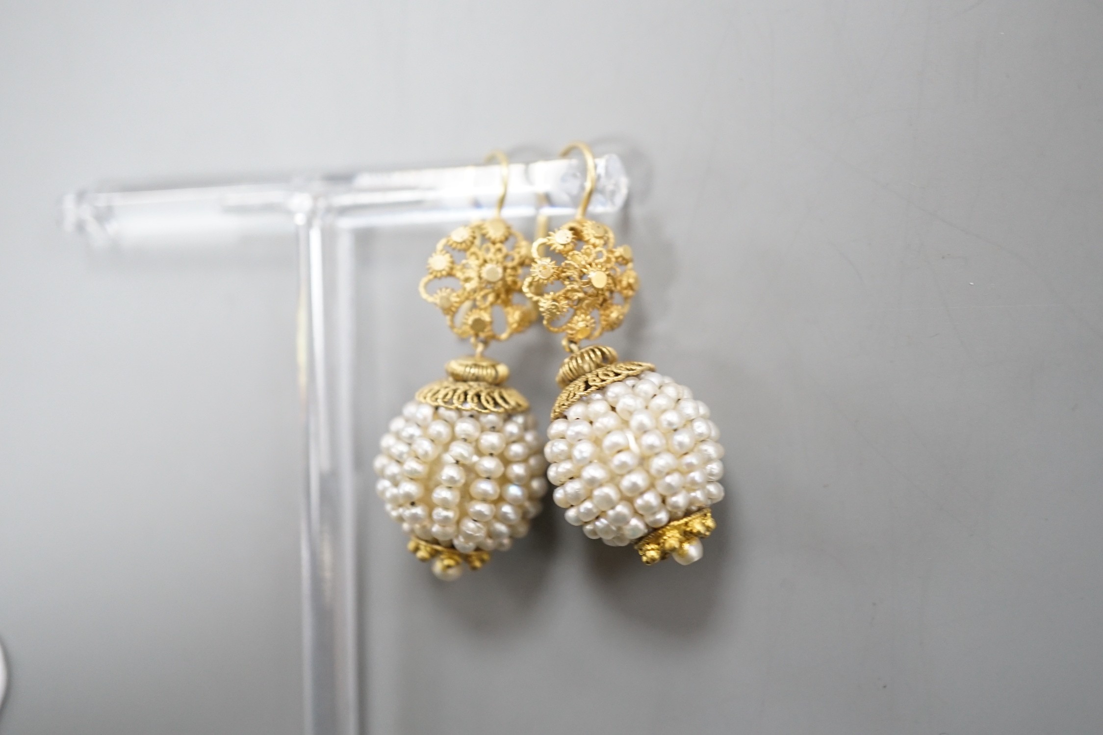 A pair of 19th century filigree yellow metal and multi seed pearl set spherical drop earrings, 34mm, gross weight 9.3 grams.
